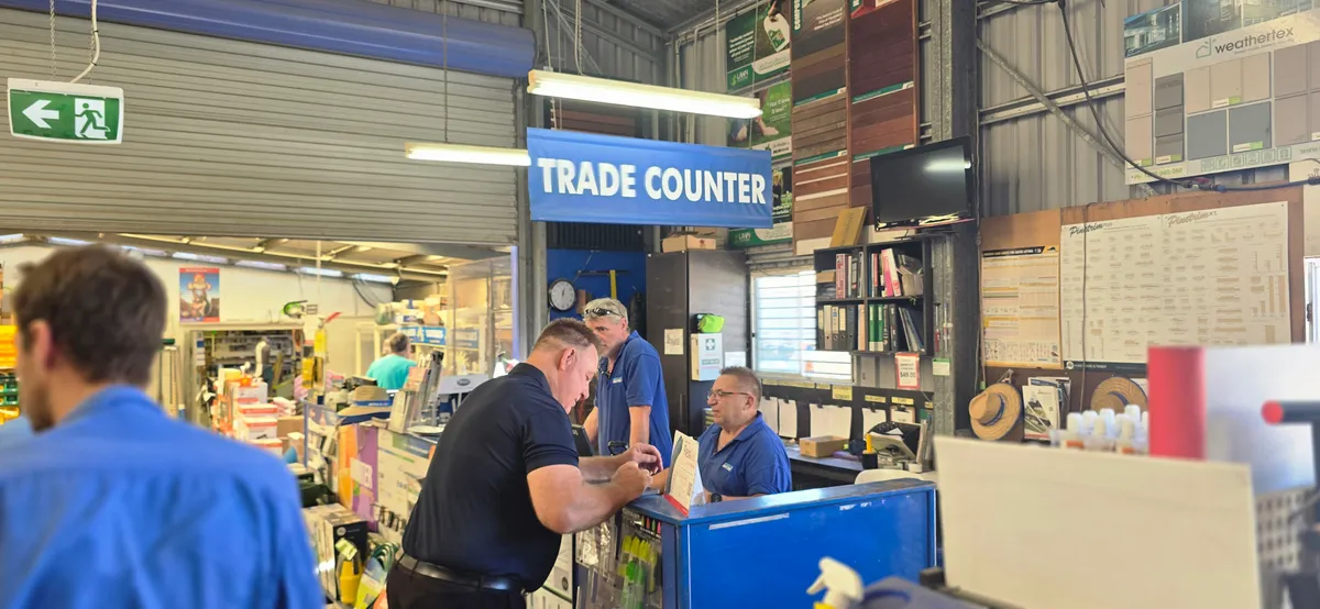 Miller's Mitre 10 trade counter   staff helping a customer
